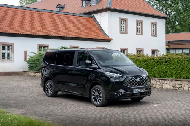 Black Ford Tourneo outside a country house