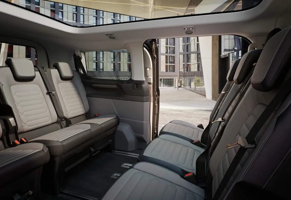Ford Tourneo example interior with facing passenger seats and an open sliding door